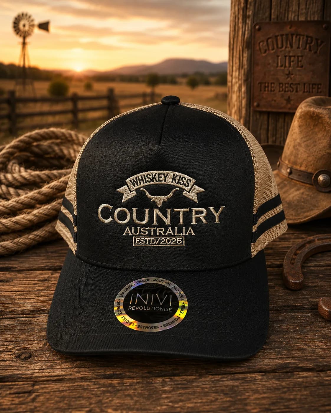 The black and tan Country Australia trucker cap on a timber table at sunset